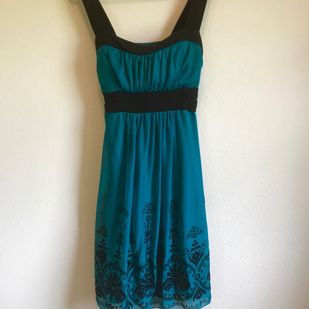 Teal dress with velvet details.